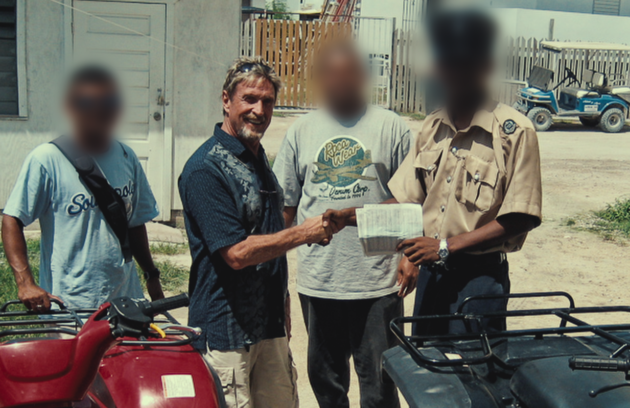 John McAfee with anonymous officials in an image from Running With the Devil: The Wild World of John McAfee. (Courtesy: Netflix)