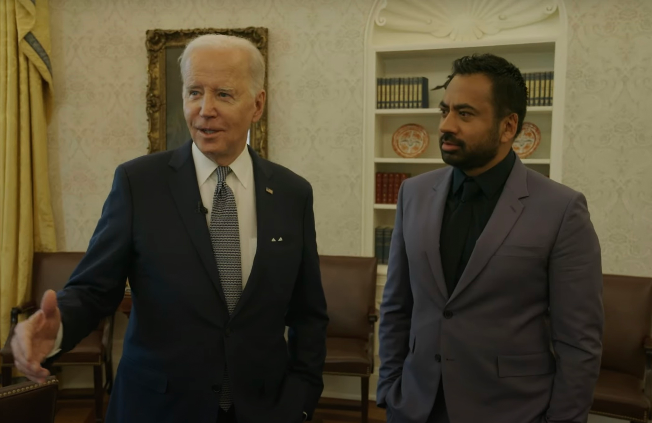 Joe Biden gives Kal Penn a tour of the Oval Office on The Daily Show. 