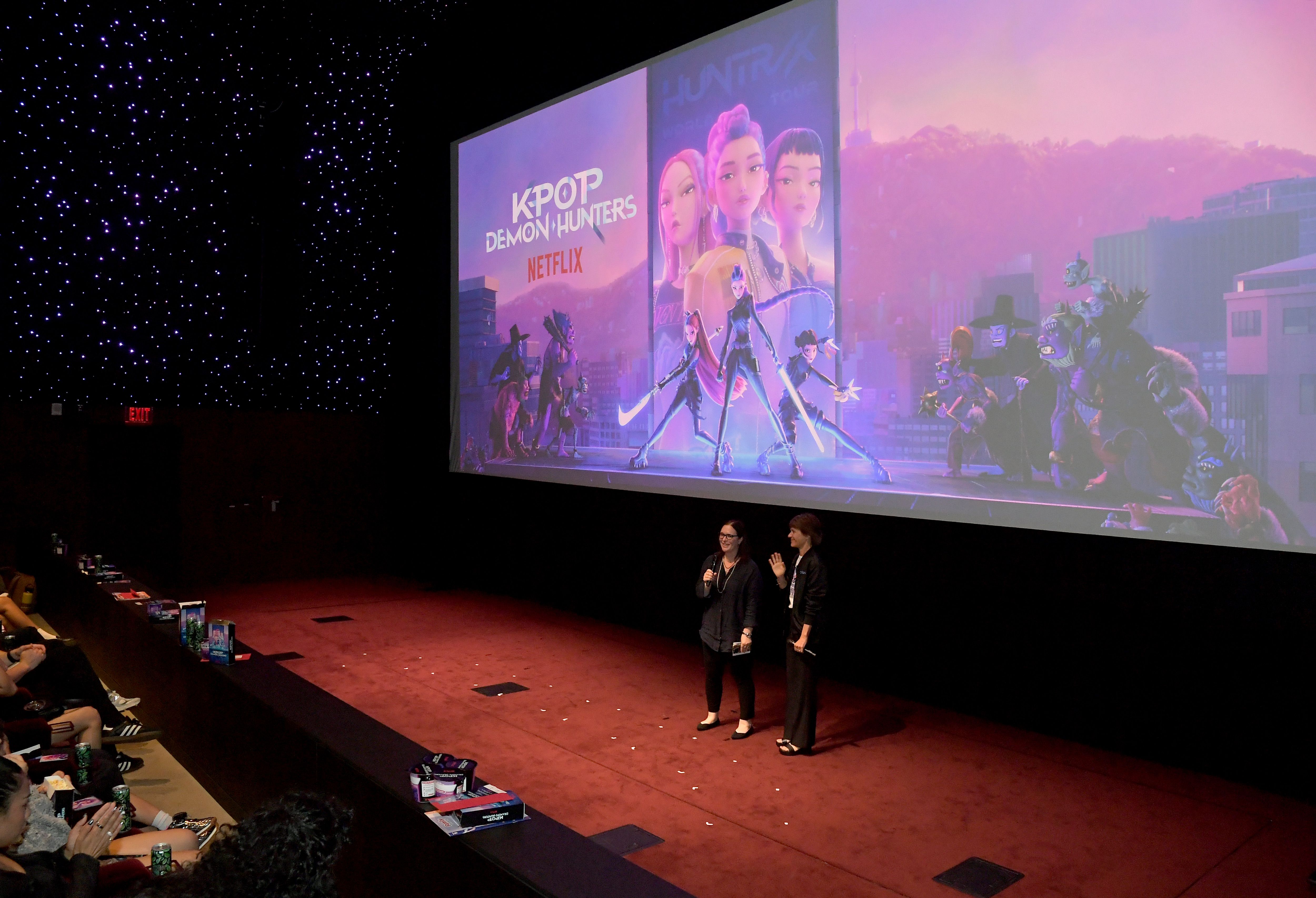 LOS ANGELES, CALIFORNIA - JUNE 16: (L-R) Hannah Minghella, Head of Feature Animation, Netflix and Kristine Belson, President, Sony Pictures Animation, speak during the KPop Demon Hunters Special Screening at Netflix Tudum Theater on June 16, 2025 in Los Angeles, California.  (Photo by Charley Gallay/Getty Images for Netflix)