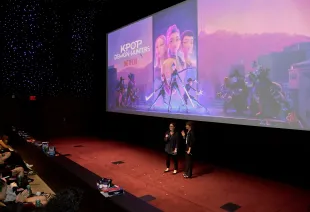LOS ANGELES, CALIFORNIA - JUNE 16: (L-R) Hannah Minghella, Head of Feature Animation, Netflix and Kristine Belson, President, Sony Pictures Animation, speak during the KPop Demon Hunters Special Screening at Netflix Tudum Theater on June 16, 2025 in Los Angeles, California.  (Photo by Charley Gallay/Getty Images for Netflix)